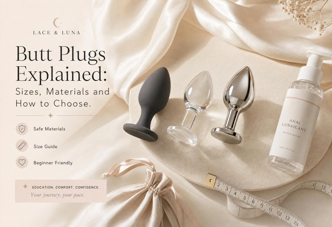 Luxury flat-lay of beginner-friendly butt plugs with flared bases, anal lubricant, toy cleaner, satin pouch and sizing guide.