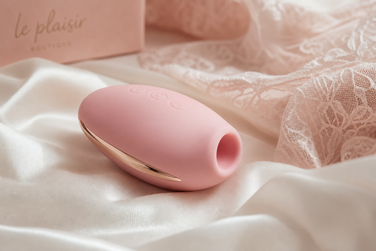 Rose pink air pulse clitoral vibrator on ivory silk, from the Lace & Luna air pulse vs clitoral vibrators guide