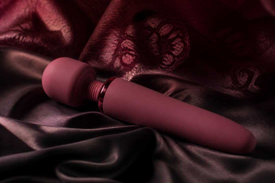 Deep mauve wand vibrator on dark silk, from the Lace & Luna wand vibrators buying guide