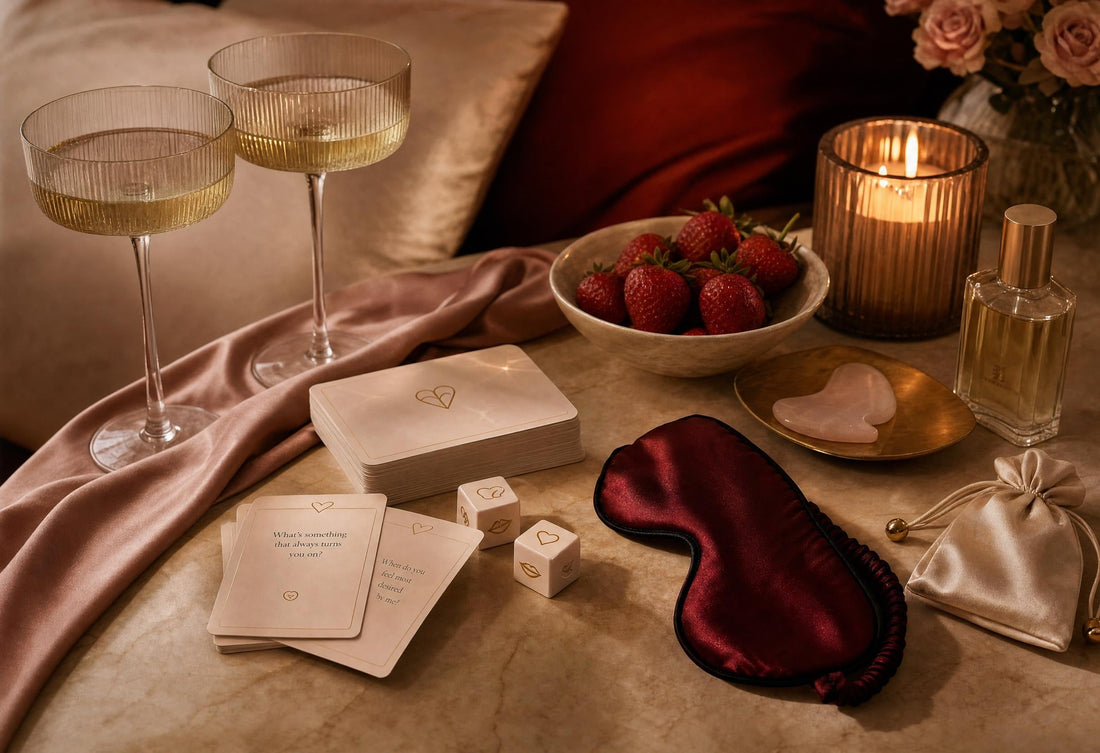 Luxury flat-lay of couples card game, dice, blindfold, candle, champagne glasses and romantic date-night essentials.
